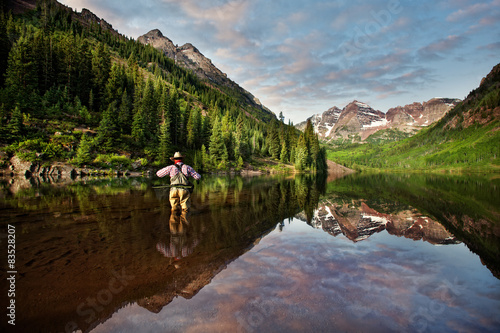 USA, Colorado, Pitkin County, Angler on Maroon Lake reflecting Maroon Bells photo