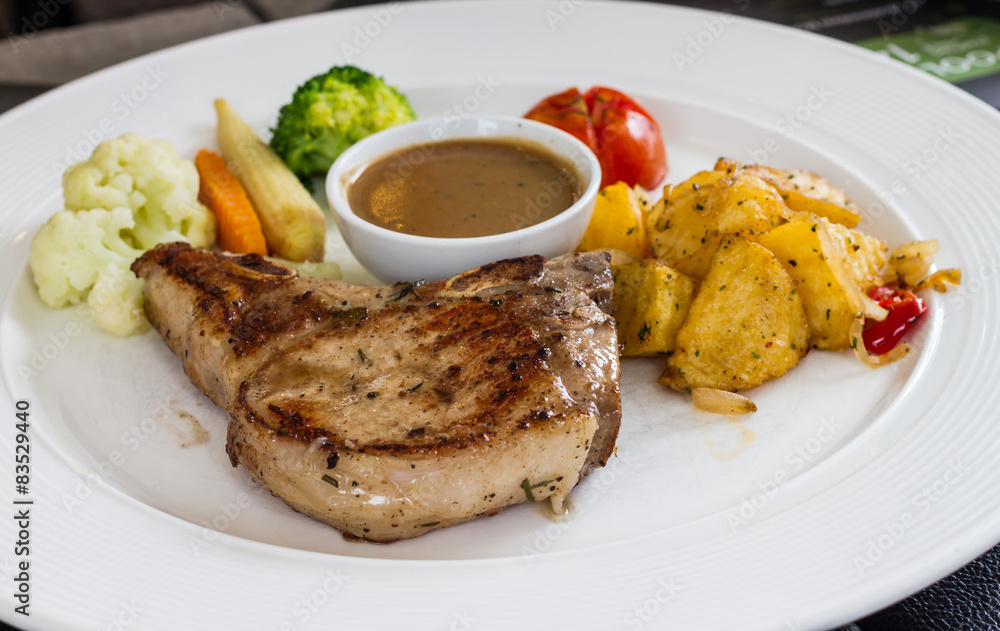porkchop served on white dish porkchop served on white dish
