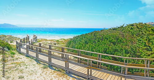 wooden boardwalk by the shore in Capo Testa