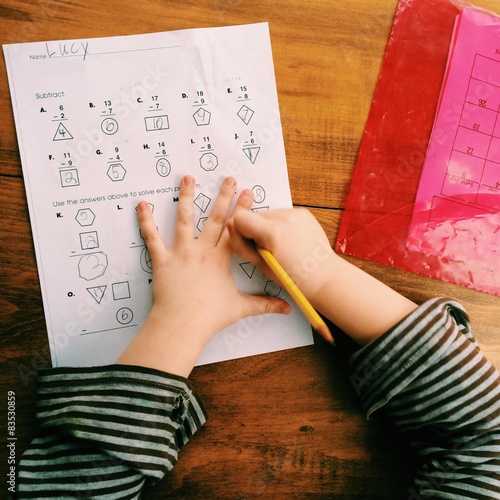 Girl (6-7) doing her homework photo