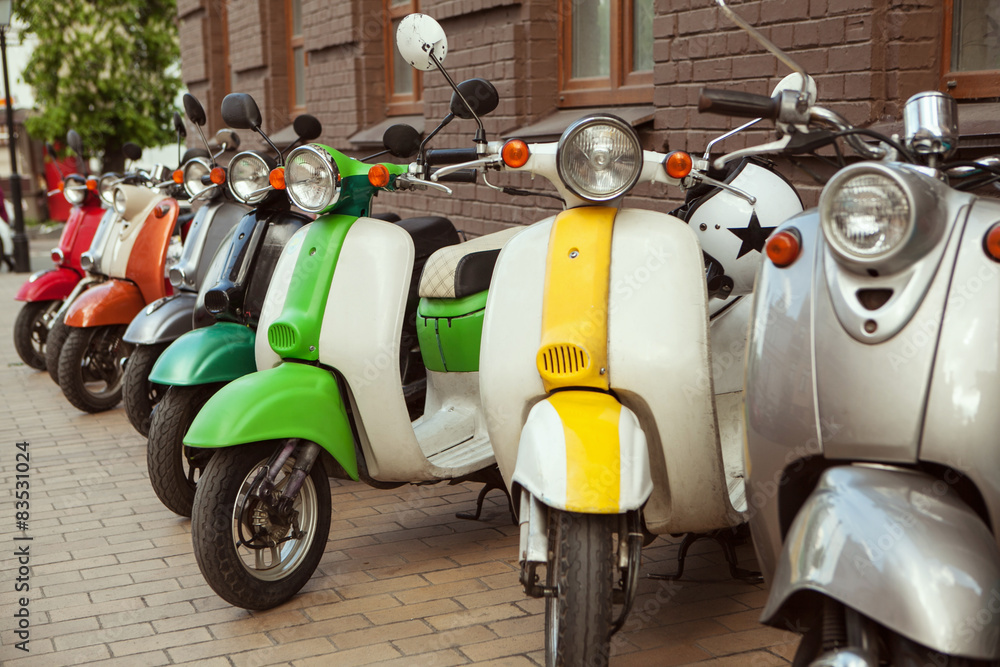 Row of mopeds on a street 