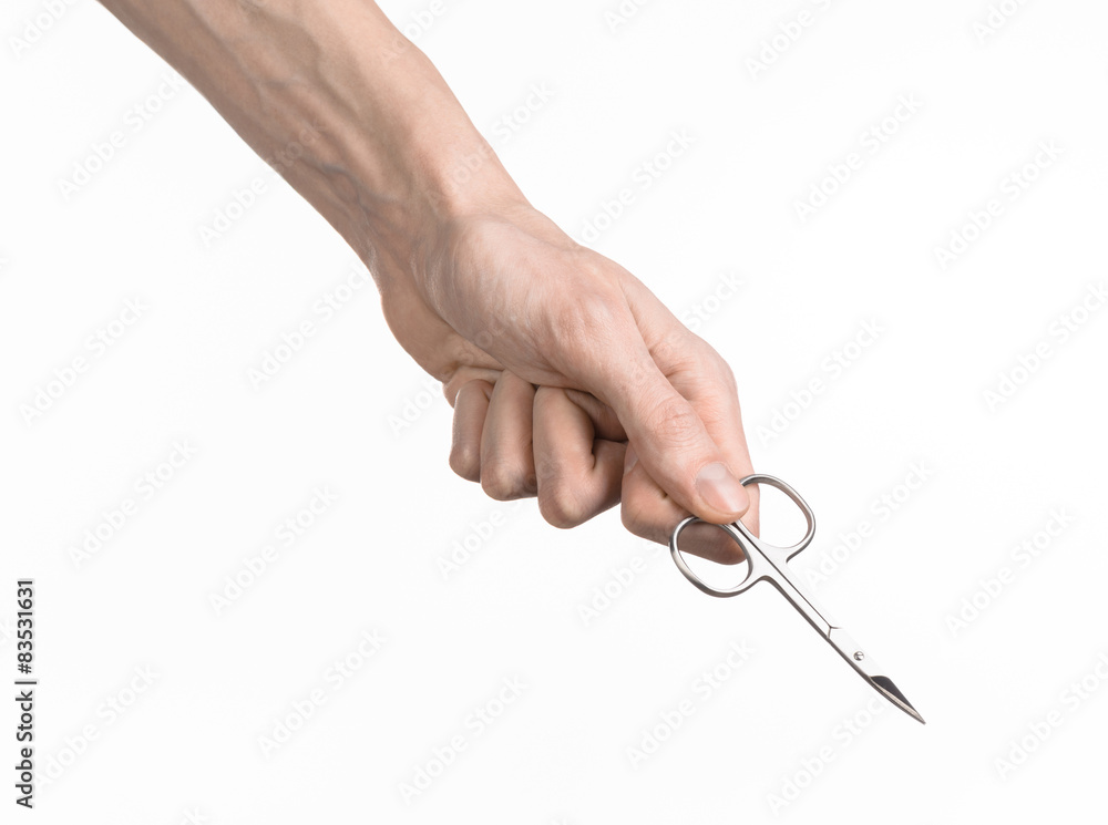 Hand holding scissors for manicure isolated on white background Hand holding scissors for manicure isolated on white background