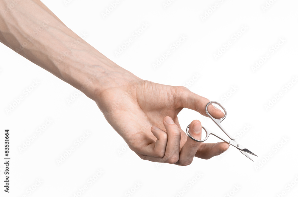 Hand holding scissors for manicure isolated on white background Hand holding scissors for manicure isolated on white background