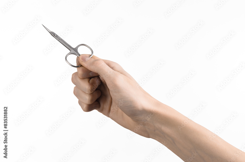 Hand holding scissors for manicure isolated on white background Hand holding scissors for manicure isolated on white background