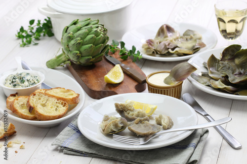 eating boiled artichoke photo