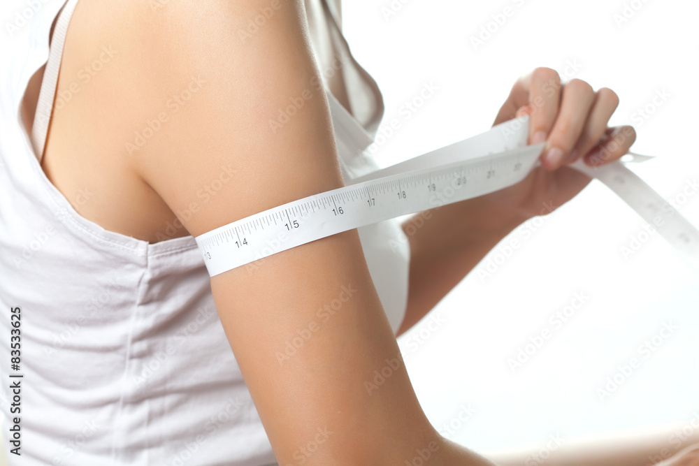 Young woman on diet measuring her fat, Beauty body care and diet