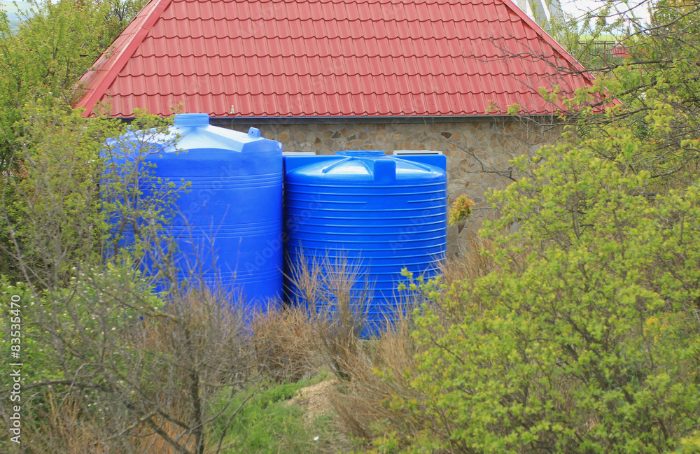 Blue water tank on the tower in park Blue water tank on the tower in park