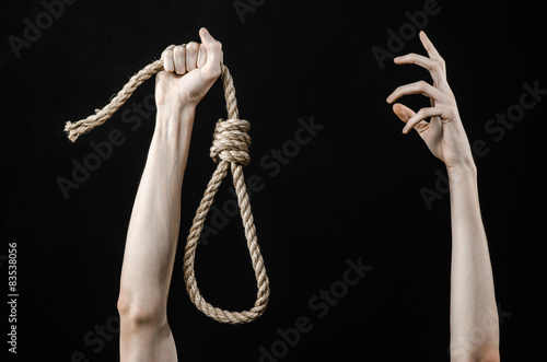 man's hand holding a loop of rope for hanging on isolated