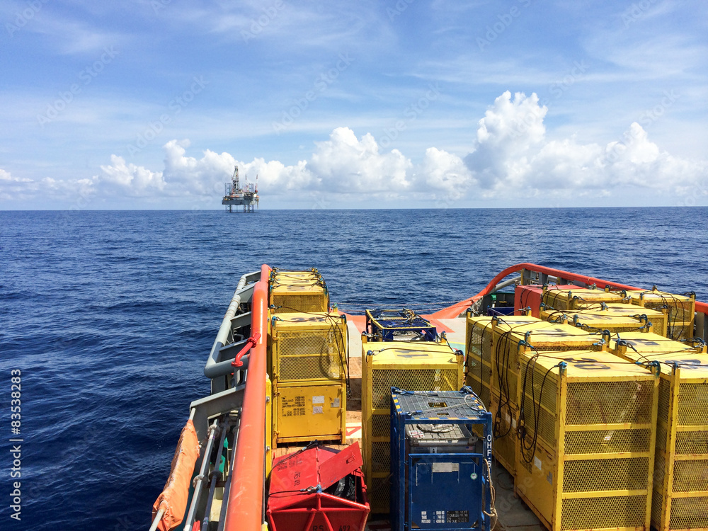 Oil Rig Protection Vessels Oil rig support vessel transporting cargo to oil rig seen on horizon ...
