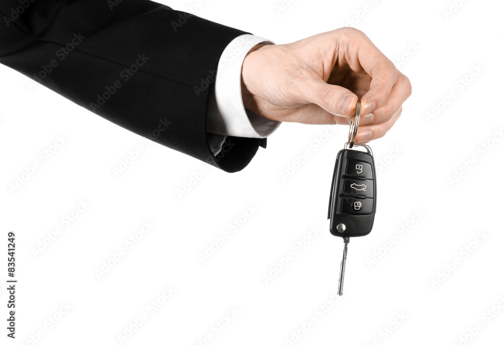 car salesman in a black suit holding a car key isolated car salesman in a black suit holding a car key isolated