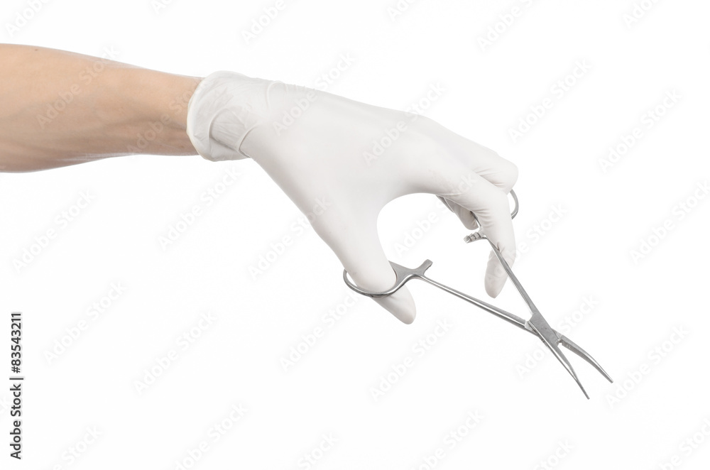 doctor's hand in a white glove holding a surgical clip isolated doctor's hand in a white glove holding a surgical clip isolated