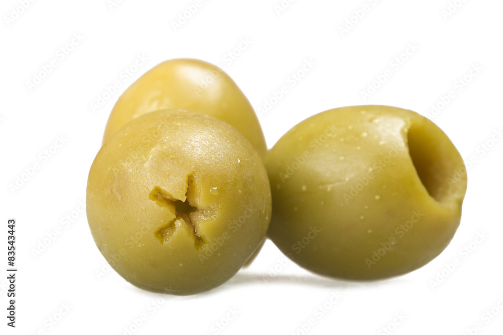 Pitted green olives close up on the white Pitted green olives close up on the white