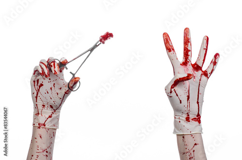 doctor bloody hand in glove holding a surgical clamp with swab