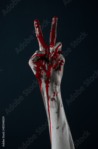 horrible zombie demon bloody hands on a black background