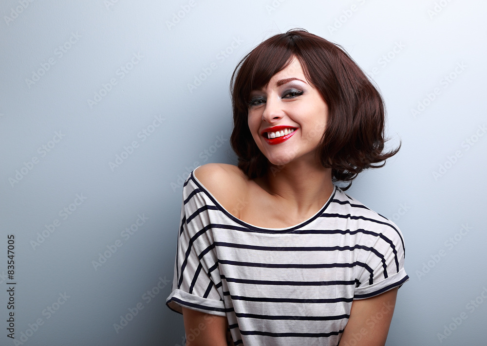 Happy smiling young woman with short hair on blue Happy smiling young woman with short hair on blue