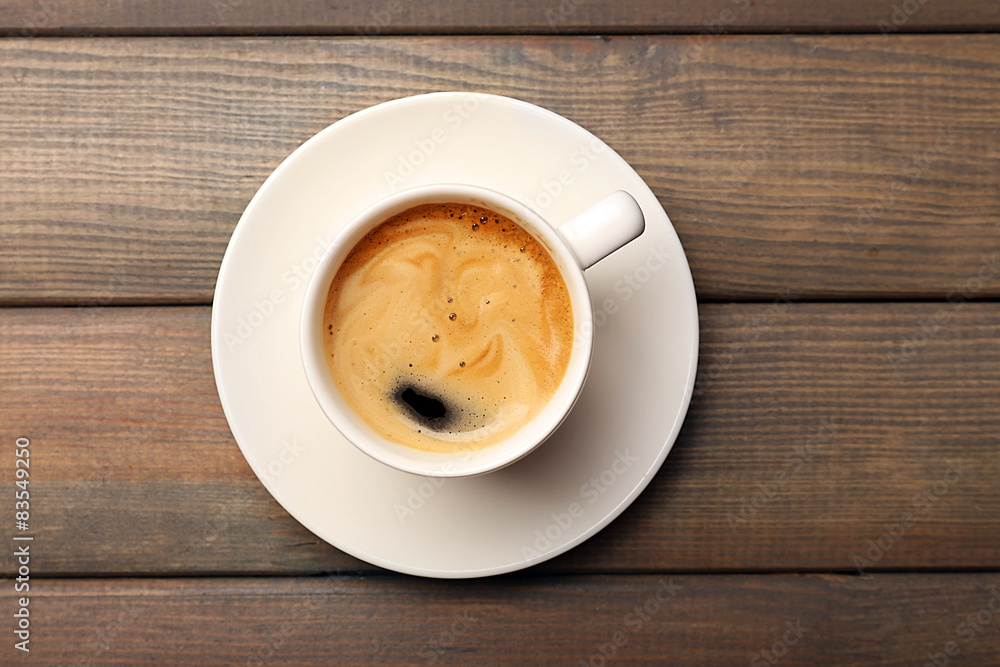 Cup of coffee on wooden table, top view Cup of coffee on wooden table, top view