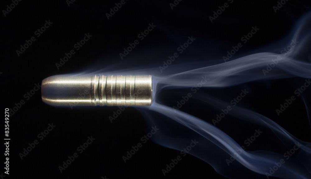 Copper bullet and smoke on black Copper bullet and smoke on black