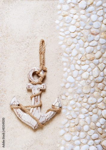 Decorative anchor on the sea sand