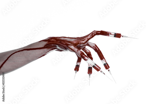 Bloody hand with syringe on the fingers, toes syringes in studio