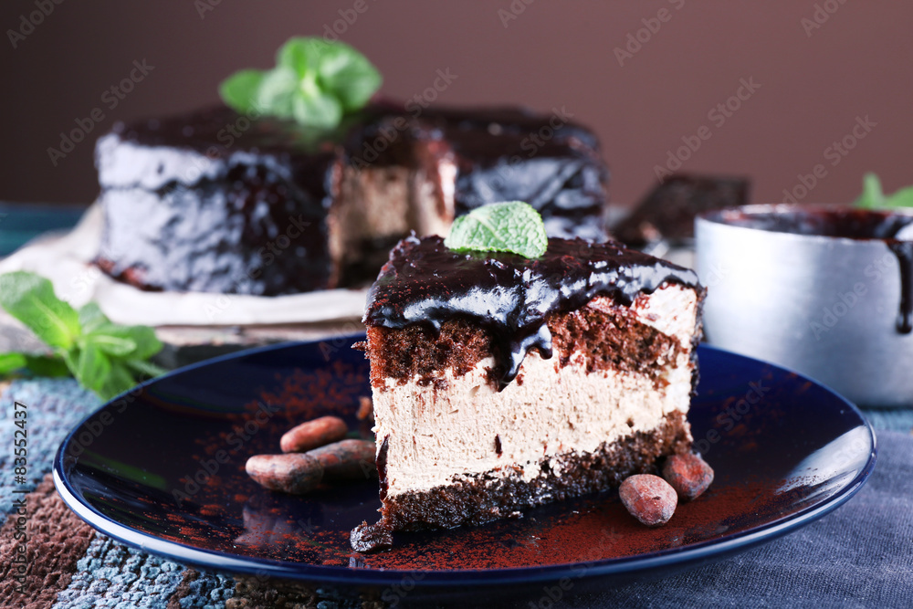 Delicious chocolate cake with icing in plate on table, closeup Delicious chocolate cake with icing in plate on table, closeup