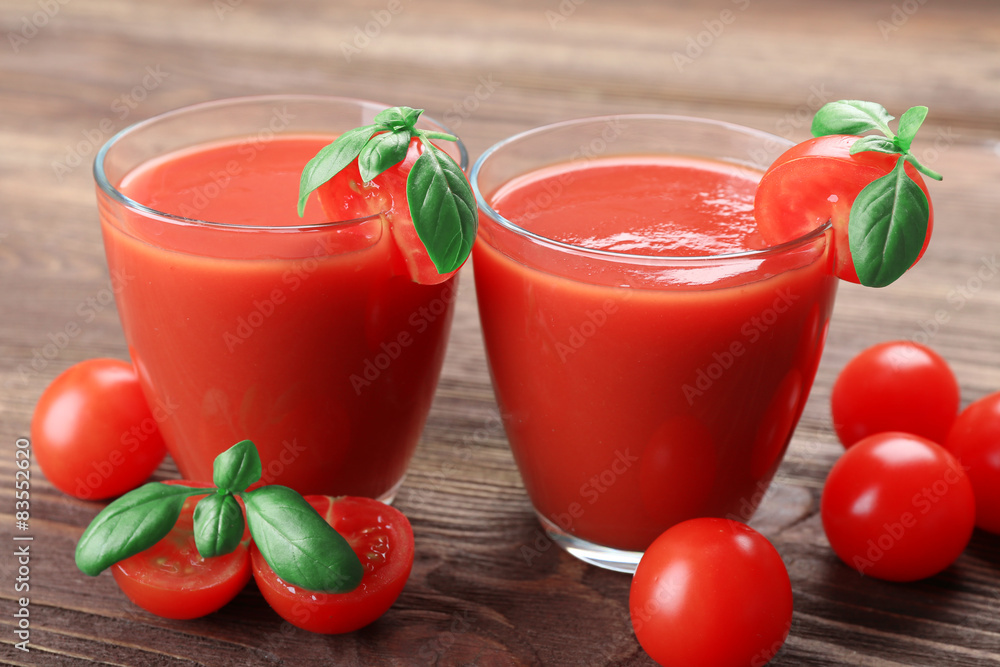 Glasses of tomato juice with vegetables on wooden background Glasses of tomato juice with vegetables on wooden background