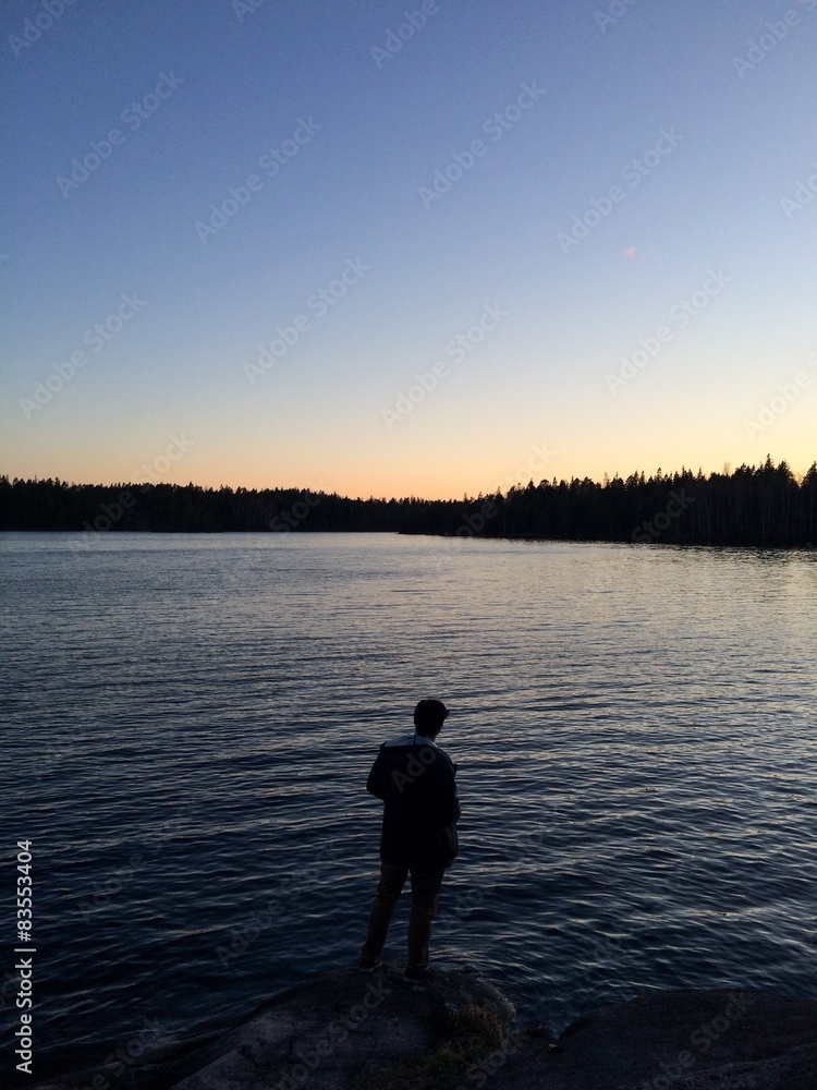 Man standing next to a lake