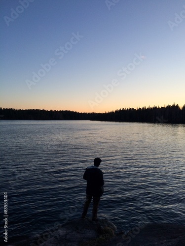 Man standing next to a lake