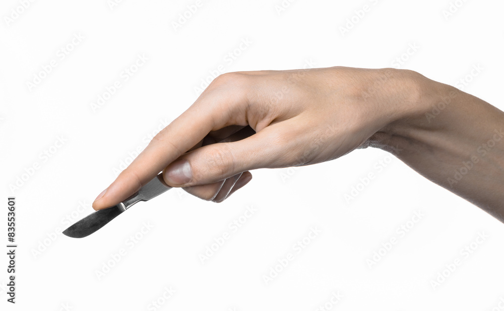 The hand holding the scalpel, white background, isolated studio