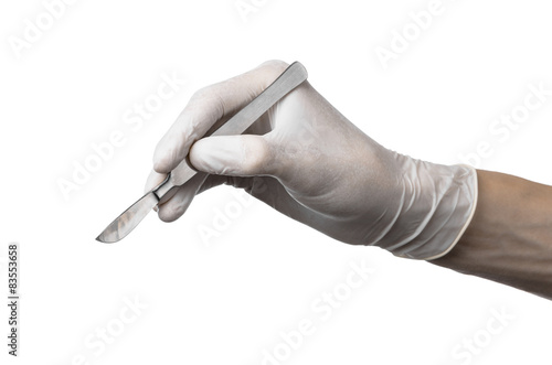 Scalpel in hand in glove on white background, isolated studio