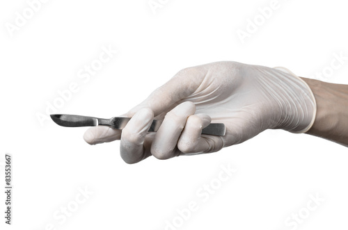 Scalpel in hand in glove on white background, isolated studio