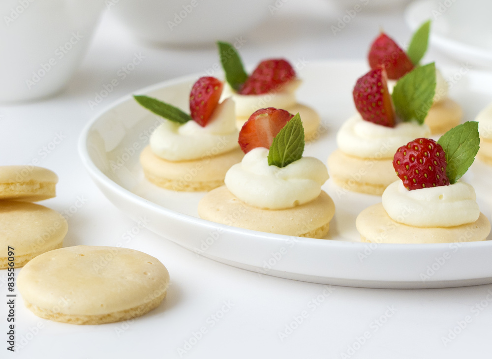 Small biscuits with strawsberries, whipped cream, mint Small biscuits with strawsberries, whipped cream, mint