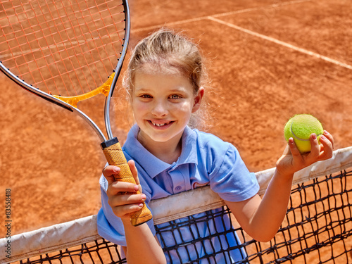 Girl athlete  with racket and ball on  tennis court