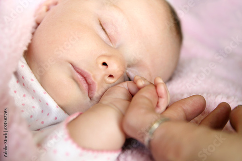 Sleeping Baby Girl Holding Mother's Hand