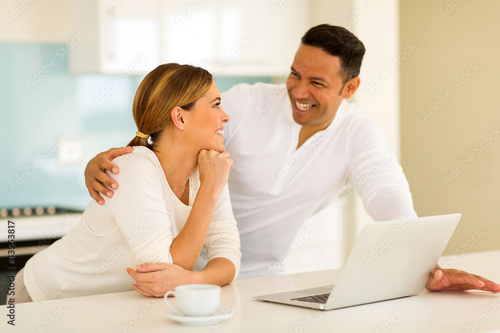 couple having conversation in kitchen couple having conversation in kitchen