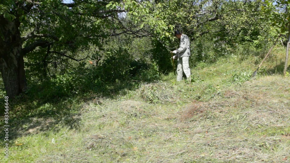 Man working in garden, burning hay and grass; Man working in garden, burning hay and grass;