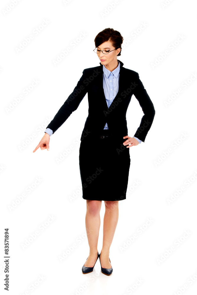 Businesswoman pointing down. Businesswoman pointing down.