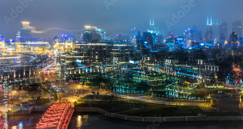 Blurred city lights and office buildings