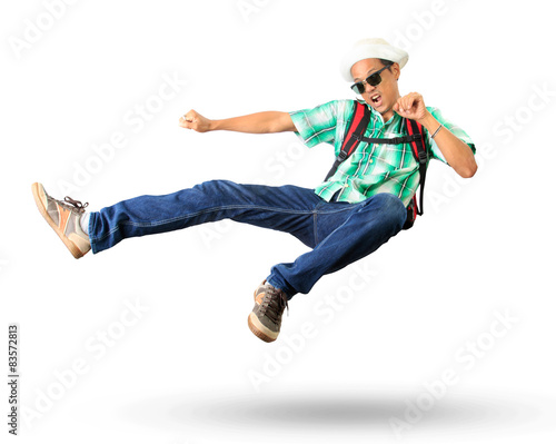 young man with back pack sky kick jumping action isolated white © stockphoto mania