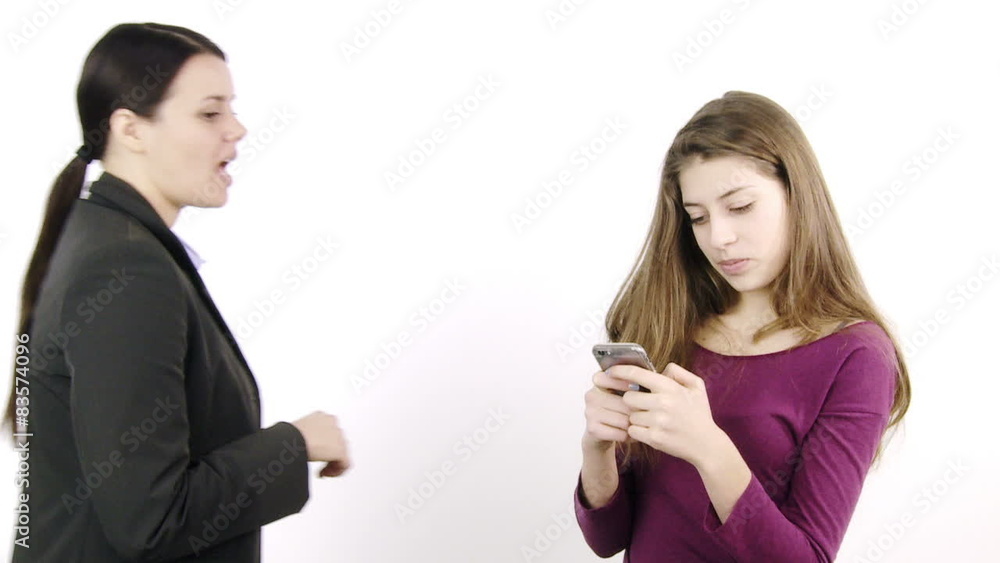 Woman furious with daughter playing with cell phone Woman furious with daughter playing with cell phone
