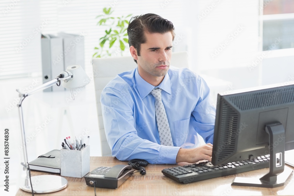 Concentrated businessman typing on the keyboard Concentrated businessman typing on the keyboard