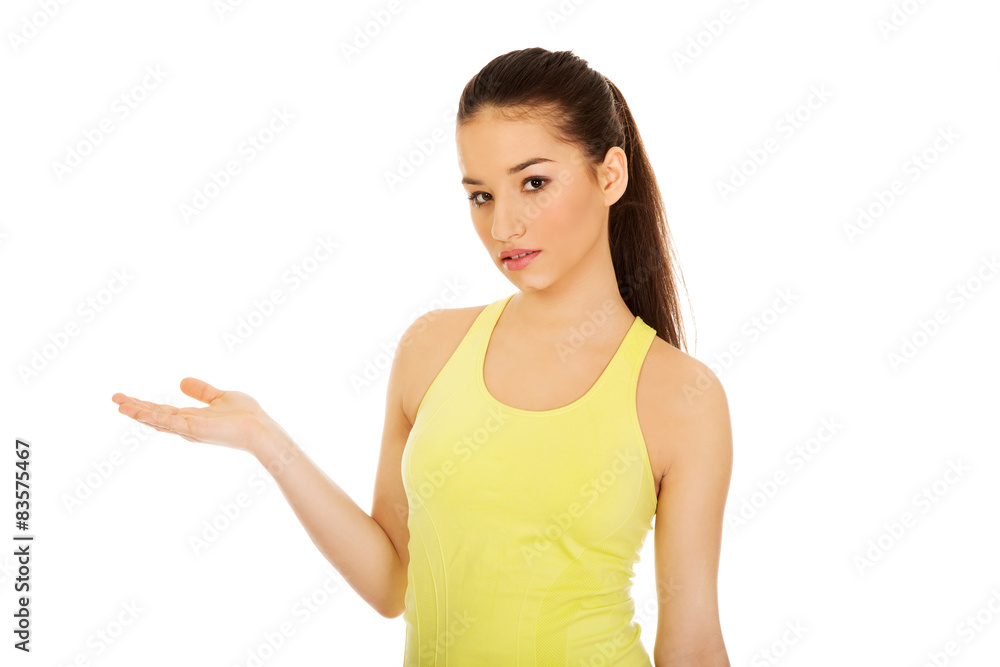 Beautiful woman in sportswear with empty hand. Beautiful woman in sportswear with empty hand.