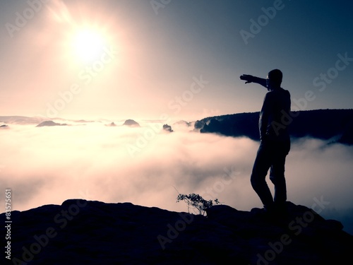 Man stand on peak of rock empire and watch into nature miracle  © rdonar