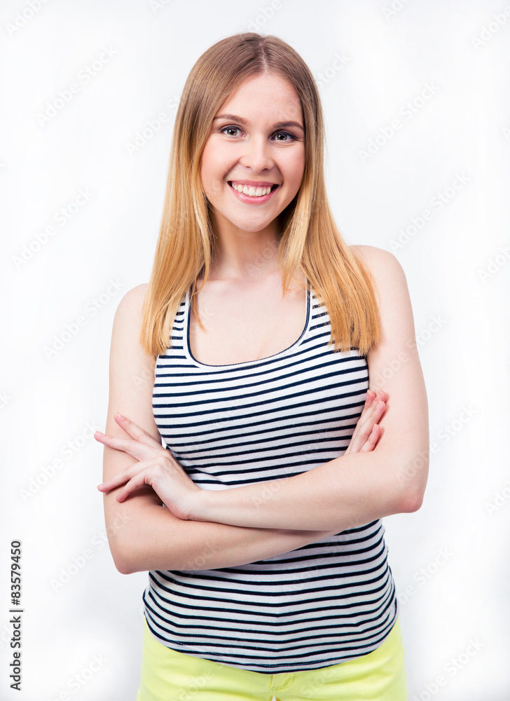Happy young woman standing with arms folded Happy young woman standing with arms folded