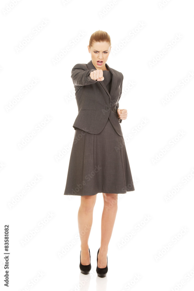 Businesswoman screaming and shaking her fist. Businesswoman screaming and shaking her fist.