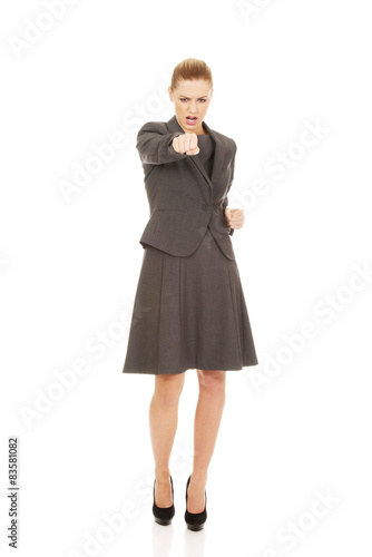 Businesswoman screaming and shaking her fist.