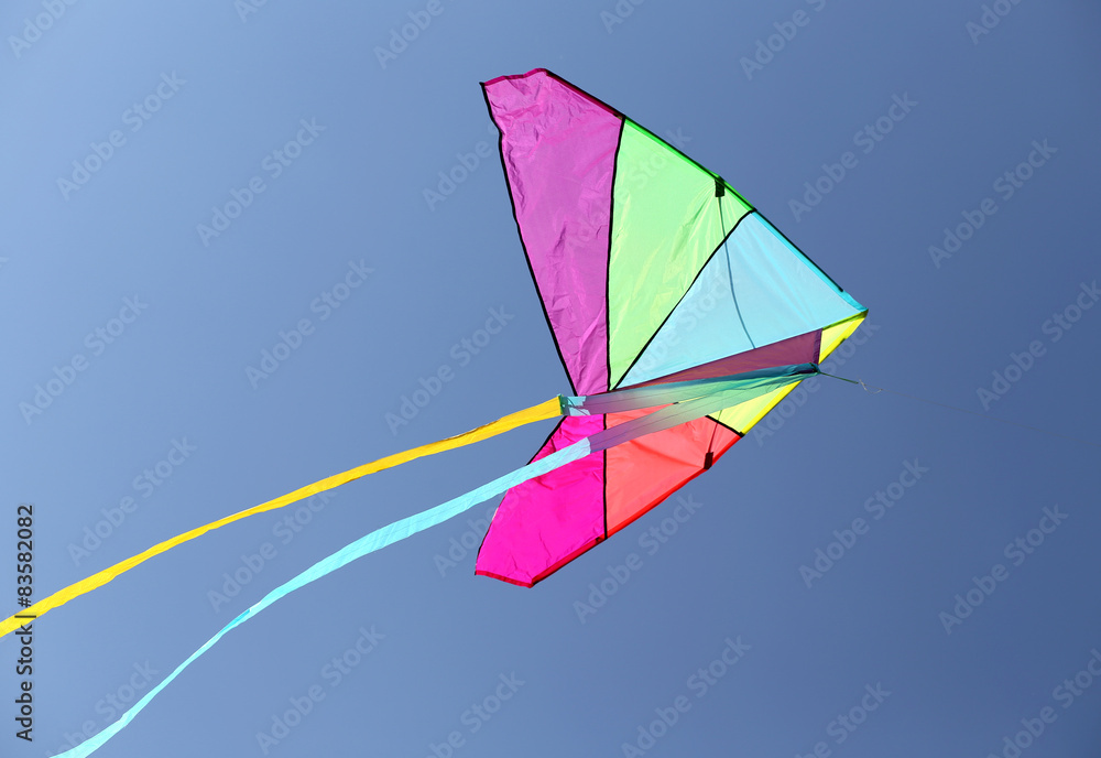 colorful kite flying high in the sky blue