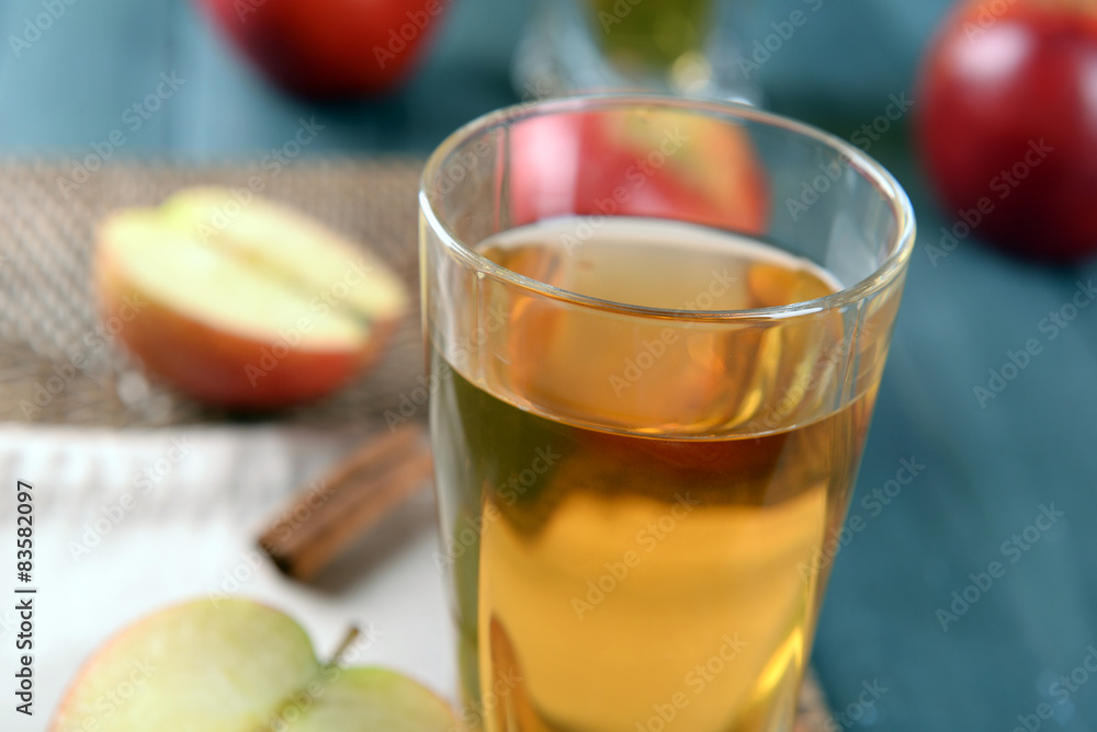 Glass of apple juice on wooden table, closeup Glass of apple juice on wooden table, closeup