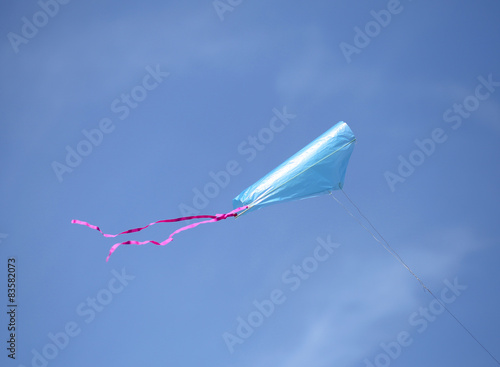 Azure kite flies high in the sky