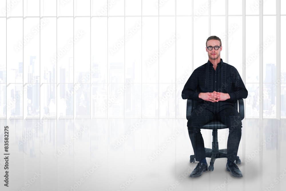 Composite image of stern businessman sitting on an office chair Composite image of stern businessman sitting on an office chair