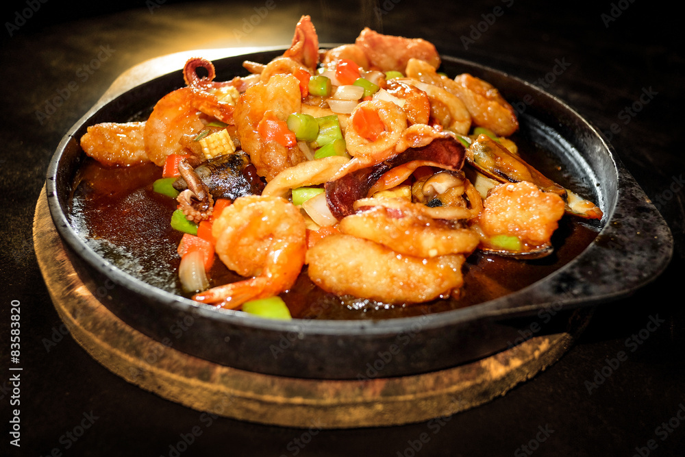 Seafood Prepared In A Frying Pan and black background Seafood Prepared In A Frying Pan and black background